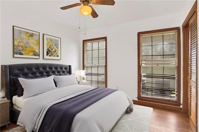 327 Alpine St, Mobile, AL 36611 - bedroom with wood finished floors, a ceiling fan, and multiple windows