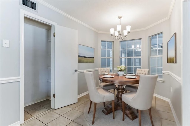 tiled dining room with crown molding and an inviting chandelier