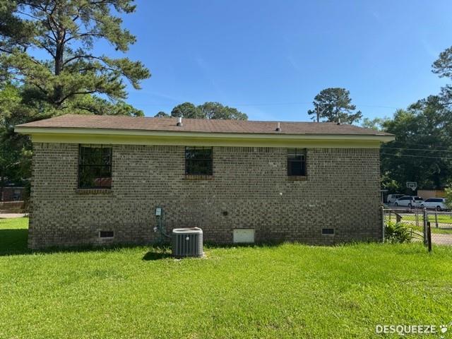 303 Ruben Ave, Saraland, AL 36571 - back of property with crawl space, central AC unit, and brick siding