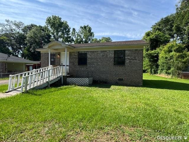 303 Ruben Ave, Saraland, AL 36571 - view of front facade with brick siding, a front yard, and crawl space