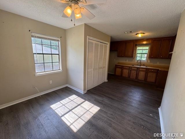 303 Ruben Ave, Saraland, AL 36571 - kitchen featuring a textured ceiling, a sink, dark wood finished floors, a ceiling fan, and baseboards