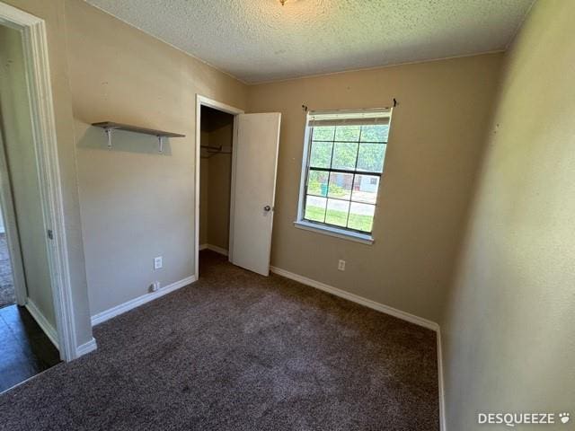 303 Ruben Ave, Saraland, AL 36571 - unfurnished bedroom featuring a textured ceiling, carpet, baseboards, and a closet