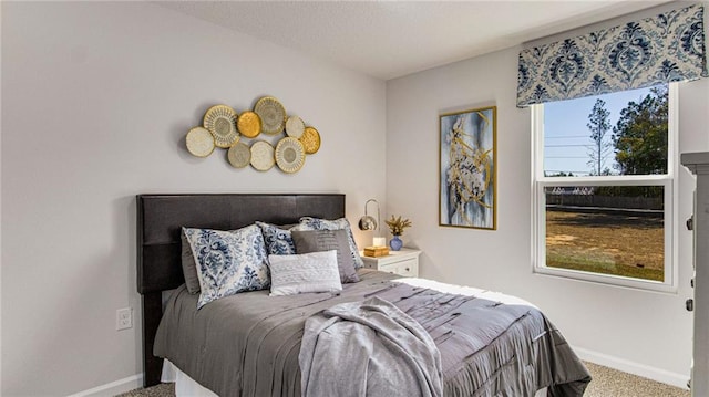 carpeted bedroom with multiple windows