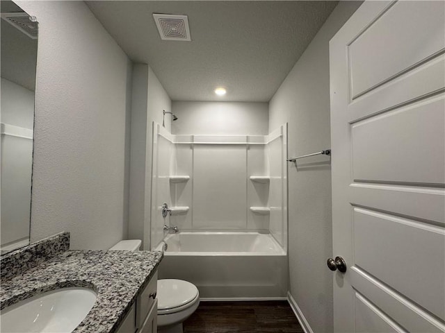 full bathroom featuring shower / bathing tub combination, hardwood / wood-style floors, vanity, and toilet