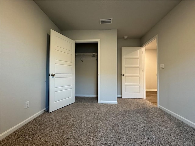 unfurnished bedroom featuring carpet floors and a closet