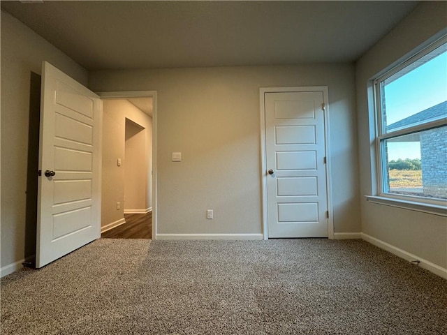 empty room with dark colored carpet