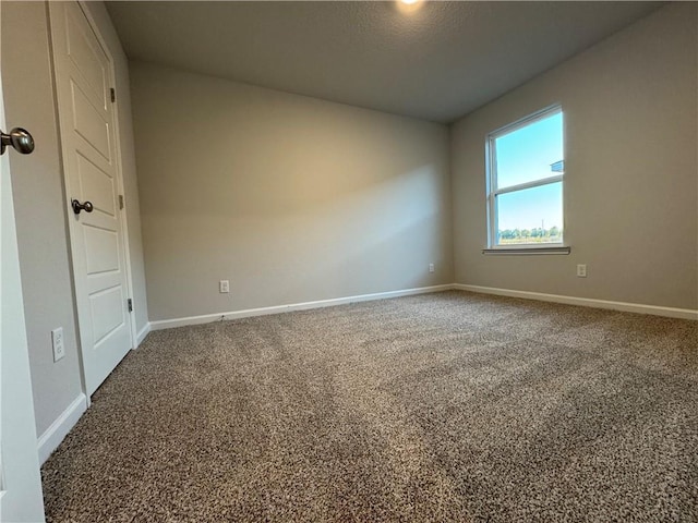 carpeted spare room featuring a textured ceiling