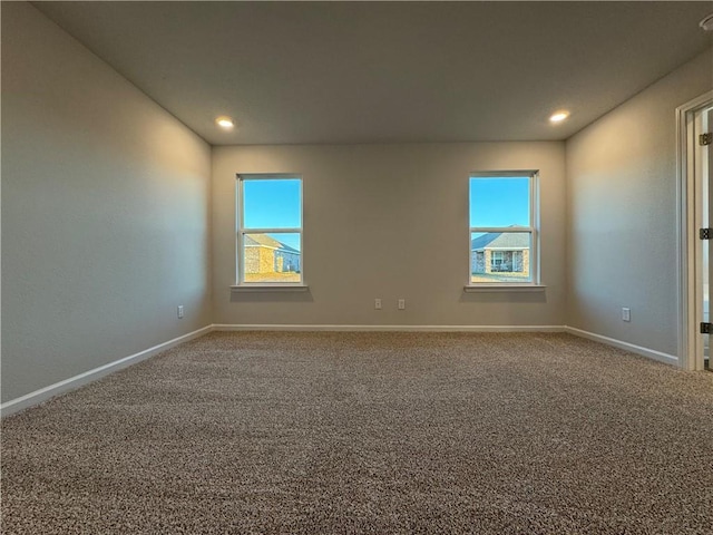 carpeted empty room featuring plenty of natural light