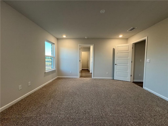 unfurnished bedroom featuring dark colored carpet