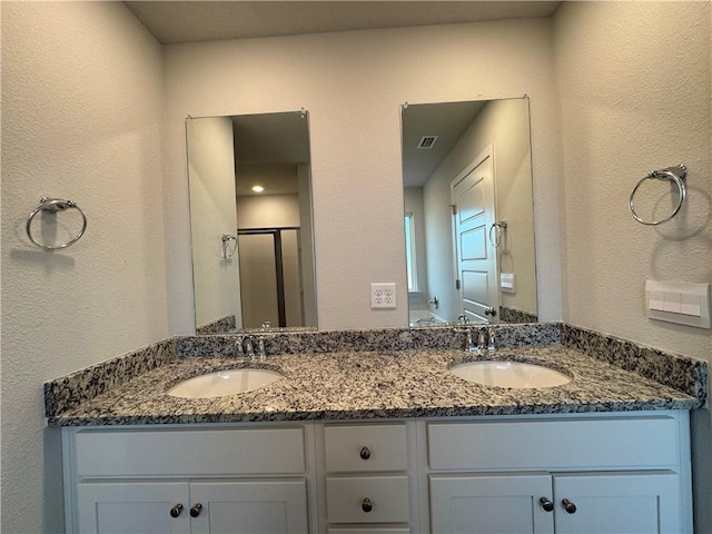 bathroom with vanity and an enclosed shower