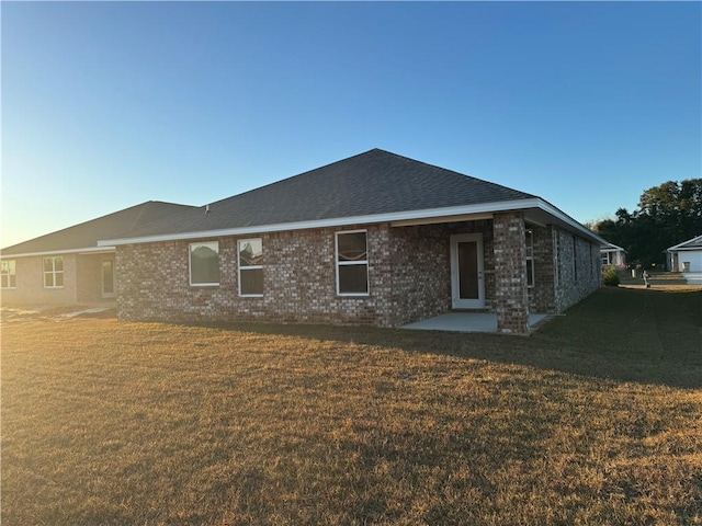 back of house with a yard and a patio area