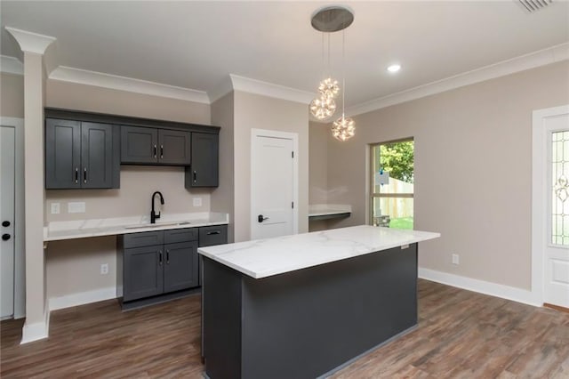 284 Magnolia Dr, Mobile, AL 36617 - kitchen with a sink, dark wood-style floors, pendant lighting, crown molding, and baseboards