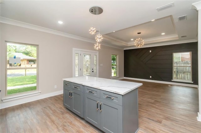 284 Magnolia Dr, Mobile, AL 36617 - kitchen featuring gray cabinets, crown molding, a chandelier, open floor plan, and light wood finished floors