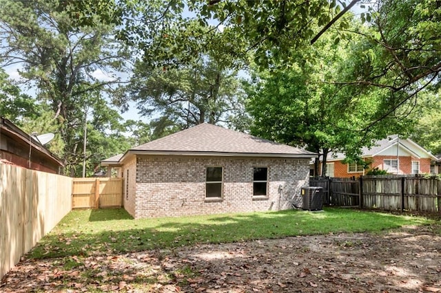 284 Magnolia Dr, Mobile, AL 36617 - rear view of property with brick siding, central AC, and roof with shingles