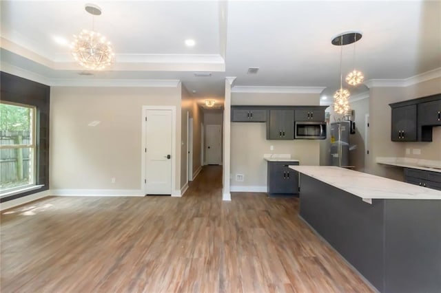 284 Magnolia Dr, Mobile, AL 36617 - kitchen with stainless steel microwave, a chandelier, fridge, ornamental molding, and a tray ceiling
