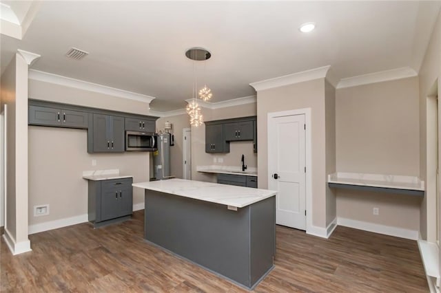 284 Magnolia Dr, Mobile, AL 36617 - kitchen with stainless steel microwave, crown molding, baseboards, light stone countertops, and a kitchen island