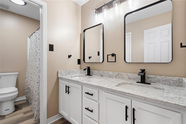 bathroom featuring toilet, a shower with curtain, wood-type flooring, and vanity