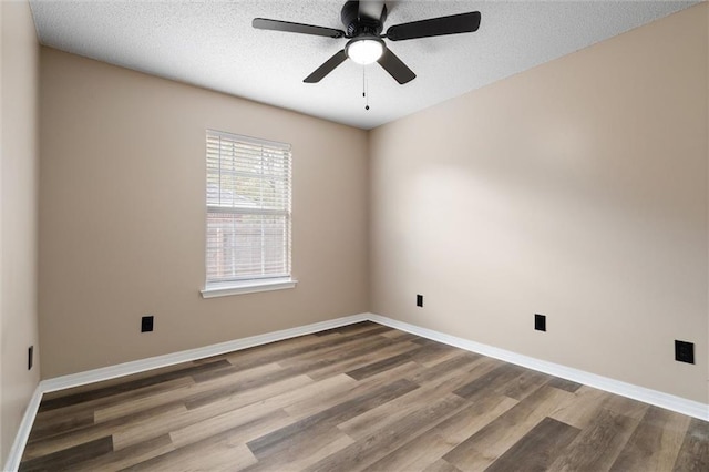 empty room with a textured ceiling, ceiling fan, and hardwood / wood-style floors