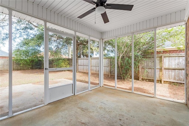 unfurnished sunroom with ceiling fan