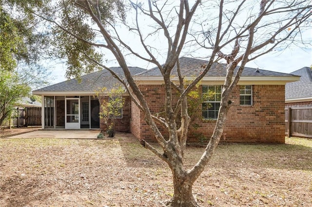 back of house featuring a sunroom and a patio