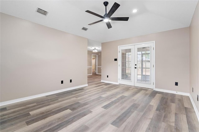 unfurnished room with ceiling fan, french doors, and hardwood / wood-style floors