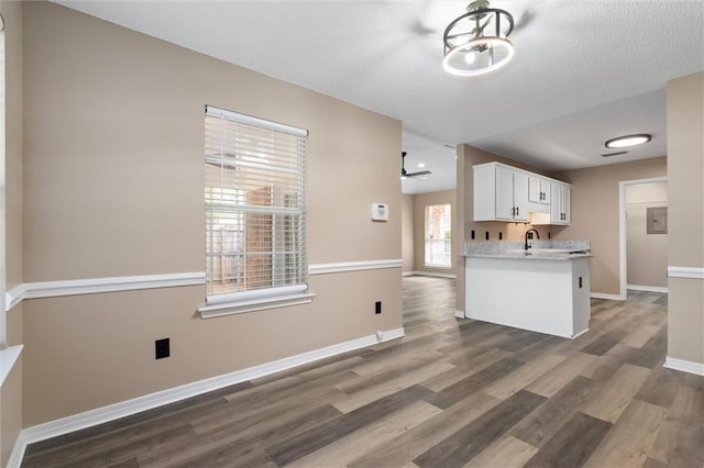 kitchen with ceiling fan, white cabinets, dark hardwood / wood-style floors, and sink