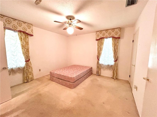 1113 Carre Dr W, Mobile, AL 36618 - unfurnished bedroom with carpet, ceiling fan, and a textured ceiling