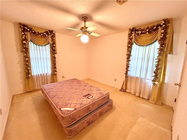 1113 Carre Dr W, Mobile, AL 36618 - bedroom featuring light carpet, multiple windows, and a ceiling fan