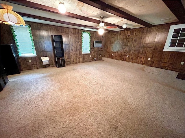 1113 Carre Dr W, Mobile, AL 36618 - carpeted empty room featuring wooden walls, beam ceiling, and a ceiling fan