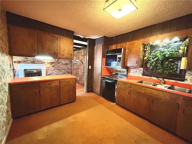 1113 Carre Dr W, Mobile, AL 36618 - kitchen featuring black appliances, light countertops, a fireplace, wood walls, and a textured ceiling