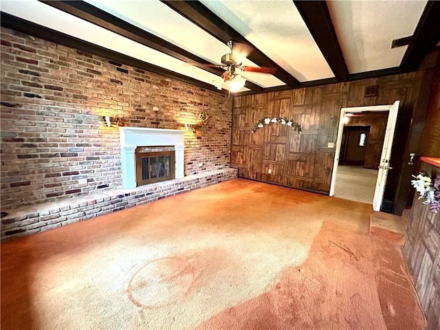 1113 Carre Dr W, Mobile, AL 36618 - unfurnished living room with light carpet, beam ceiling, ceiling fan, and a brick fireplace
