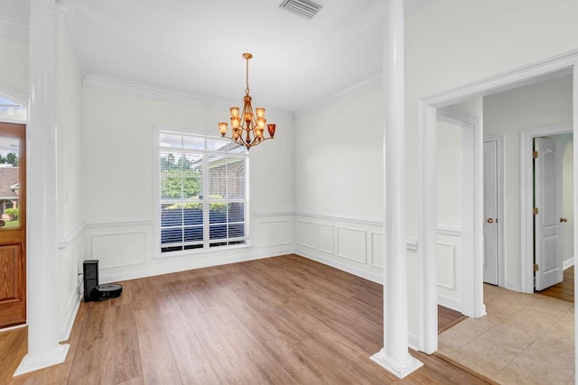 8705 Floyd Crabtree Way, Semmes, AL 36575 - unfurnished dining area with a chandelier, light wood-style flooring, wainscoting, crown molding, and a decorative wall