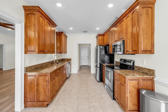 8705 Floyd Crabtree Way, Semmes, AL 36575 - kitchen with stainless steel appliances, crown molding, dark stone counters, brown cabinets, and recessed lighting