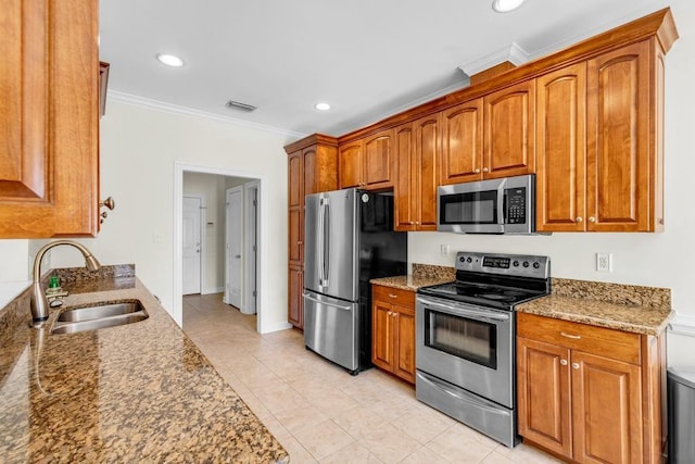 8705 Floyd Crabtree Way, Semmes, AL 36575 - kitchen featuring appliances with stainless steel finishes, crown molding, brown cabinets, light tile patterned floors, and recessed lighting