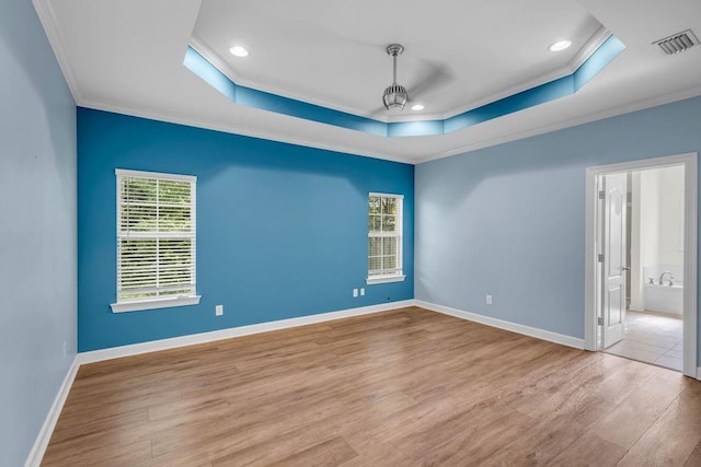 8705 Floyd Crabtree Way, Semmes, AL 36575 - empty room featuring a tray ceiling, ornamental molding, wood finished floors, and recessed lighting