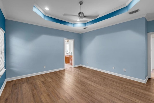 8705 Floyd Crabtree Way, Semmes, AL 36575 - empty room with a tray ceiling, a ceiling fan, crown molding, wood finished floors, and recessed lighting