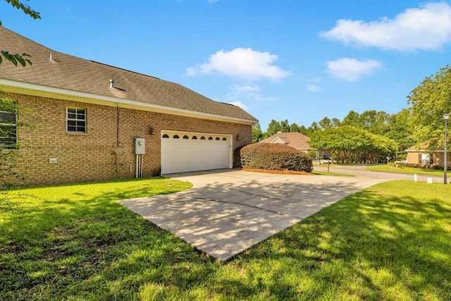 8705 Floyd Crabtree Way, Semmes, AL 36575 - view of side of property with a yard, driveway, an attached garage, and brick siding