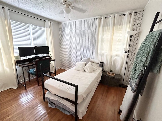 bedroom featuring ceiling fan, a textured ceiling, and hardwood / wood-style floors