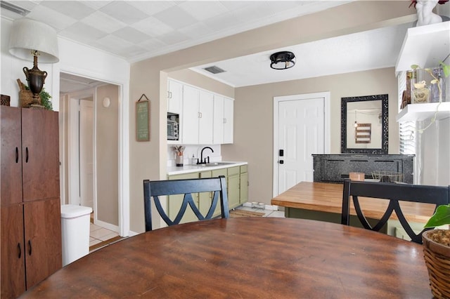 dining area featuring crown molding and visible vents