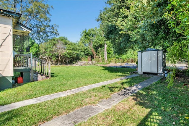 view of yard featuring a sunroom and a shed