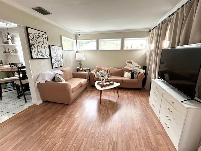 living room with light hardwood / wood-style floors and crown molding