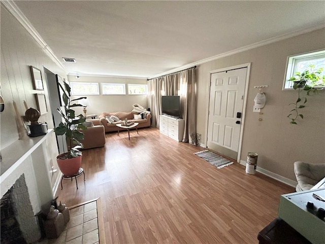 living room featuring hardwood / wood-style floors, plenty of natural light, and ornamental molding