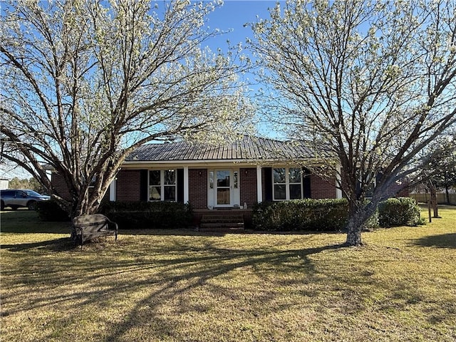 single story home featuring a front lawn and brick siding