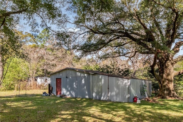 view of outdoor structure featuring a lawn