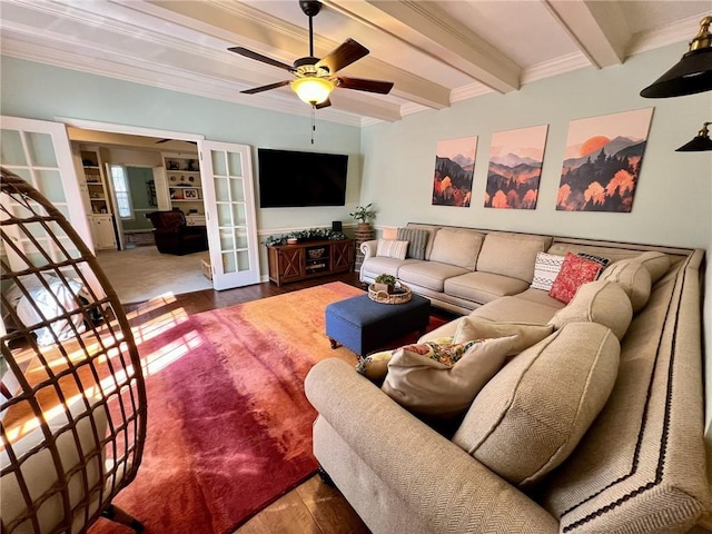 living area featuring french doors, beam ceiling, ornamental molding, ceiling fan, and wood finished floors