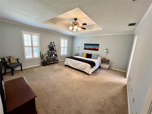 carpeted bedroom featuring a textured ceiling, ornamental molding, a raised ceiling, and baseboards