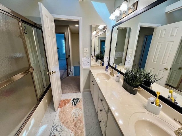 full bath with double vanity, tile patterned flooring, and a sink