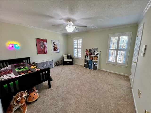 carpeted bedroom with a ceiling fan, baseboards, ornamental molding, and a textured ceiling