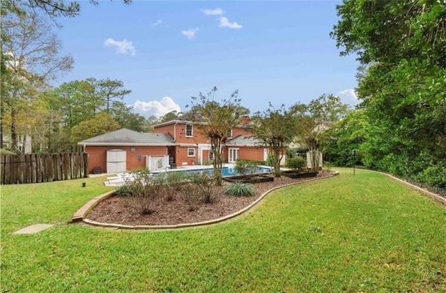 view of yard with fence and a fenced in pool