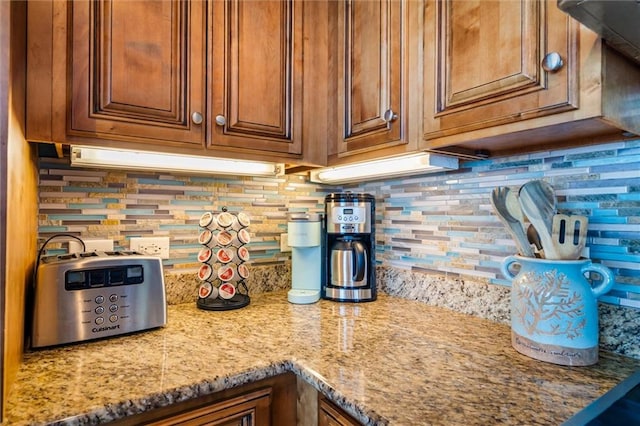 kitchen featuring backsplash and light stone countertops